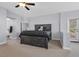 Main bedroom with dark wood bed frame and access to a bathroom at 3721 Alcantara Ln, North Las Vegas, NV 89084