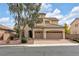 Two-story house with a three-car garage and mature tree in front at 3721 Alcantara Ln, North Las Vegas, NV 89084