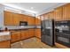 Kitchen with a large island, stainless steel appliances, and wood cabinets at 3721 Alcantara Ln, North Las Vegas, NV 89084