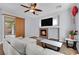 Cozy living room features a fireplace and large windows at 3721 Alcantara Ln, North Las Vegas, NV 89084