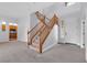 Elegant staircase with wooden railings and neutral carpeting at 3721 Alcantara Ln, North Las Vegas, NV 89084