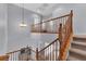 Elegant staircase with wood railing and chandelier at 3721 Alcantara Ln, North Las Vegas, NV 89084