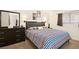 Comfortable bedroom with a double bed, dresser, and striped bedding at 3982 Voxna St, Las Vegas, NV 89119