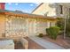 Front view of a tan house with stone accents, security door, and small front yard at 3982 Voxna St, Las Vegas, NV 89119