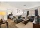 Cozy living area with gray sofas, coffee table, and view into the bedroom at 3982 Voxna St, Las Vegas, NV 89119