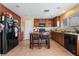 Kitchen with wood cabinets, tile floors, and island at 4204 Becket Ct, Las Vegas, NV 89129