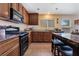 Well-equipped kitchen featuring dark wood cabinets and granite countertops at 4204 Becket Ct, Las Vegas, NV 89129