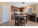 Bright kitchen with ample cabinetry, granite countertops, and an island with seating at 4204 Becket Ct, Las Vegas, NV 89129