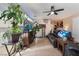 Living room with large TV, leather furniture, and tile floors at 4204 Becket Ct, Las Vegas, NV 89129