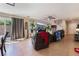 Living room with large TV, leather furniture, and tile floors at 4204 Becket Ct, Las Vegas, NV 89129