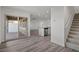 Open living area with grey vinyl flooring, access to the patio, and kitchen view at 4219 Gold Desert St, North Las Vegas, NV 89032