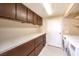 Laundry room with washer, dryer, cabinets, and shelving at 505 Ville Dr, Boulder City, NV 89005