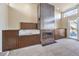 Wet bar with a sink and cabinets, adjacent to a fireplace at 505 Ville Dr, Boulder City, NV 89005