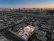 Aerial view of a house and neighborhood at dusk, Las Vegas Strip in background at 5117 Dancer Way, Las Vegas, NV 89107