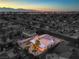 Aerial view of single-story house with backyard and pool, twilight view at 5117 Dancer Way, Las Vegas, NV 89107