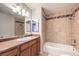 Bathroom with wood vanity, tiled shower and bathtub at 5117 Dancer Way, Las Vegas, NV 89107