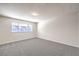 Spacious bedroom with grey carpet and a large window at 5117 Dancer Way, Las Vegas, NV 89107