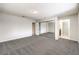 Bedroom with grey carpet, mirrored closet doors, and bathroom access at 5117 Dancer Way, Las Vegas, NV 89107