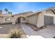 House exterior showcasing walkway and gray garage door at 5117 Dancer Way, Las Vegas, NV 89107