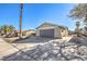 Front view of single story house with gray garage door at 5117 Dancer Way, Las Vegas, NV 89107