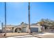 Single story house with gray garage door and mature palm tree at 5117 Dancer Way, Las Vegas, NV 89107