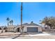 Single-story house with gray garage door and desert landscaping at 5117 Dancer Way, Las Vegas, NV 89107