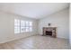 Living room with tile floors, brick fireplace and large window at 5117 Dancer Way, Las Vegas, NV 89107