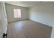 Bright bedroom with wood-look flooring and large window at 5933 Vegas Dr, Las Vegas, NV 89108