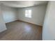 Spacious bedroom featuring wood-look floors and a window at 5933 Vegas Dr, Las Vegas, NV 89108