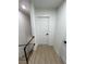 Upstairs hallway with light wood flooring and white doors at 5933 Vegas Dr, Las Vegas, NV 89108