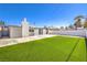 Large backyard featuring an artificial lawn and a patio area at 701 N Yale St, Las Vegas, NV 89107