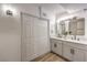 Bathroom featuring a modern double vanity, wood-look floors, and an alcove for linens at 701 N Yale St, Las Vegas, NV 89107