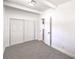 Cozy bedroom featuring white walls, plush gray carpet, and a spacious closet with sliding doors at 701 N Yale St, Las Vegas, NV 89107