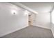 Spacious bedroom with gray carpet, white trim, and a modern lighting fixture at 701 N Yale St, Las Vegas, NV 89107