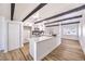 Bright kitchen with large island, white cabinets, stainless steel appliances and wood-look flooring at 701 N Yale St, Las Vegas, NV 89107