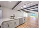 Modern kitchen with stainless sink, white cabinets, and a view of the outdoor living space at 701 N Yale St, Las Vegas, NV 89107