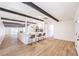 Open-concept living space with wood floors, kitchen island, and decorative beams at 701 N Yale St, Las Vegas, NV 89107