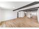 Open-concept living room with wood-look floors and a view of the kitchen and backyard at 701 N Yale St, Las Vegas, NV 89107