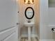 Elegant powder room with pedestal sink and oval mirror at 7024 Bluebird Wing St, North Las Vegas, NV 89084