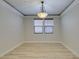 Bright dining room with light hardwood floors and crown molding at 7024 Bluebird Wing St, North Las Vegas, NV 89084