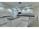 Spacious kitchen with island, white cabinets and granite countertops at 7024 Bluebird Wing St, North Las Vegas, NV 89084