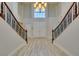 Grand double staircase with ornate railing and hardwood flooring at 7024 Bluebird Wing St, North Las Vegas, NV 89084