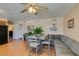 Dining area with gray sectional and wood floors at 7037 Pleasant View Ave, Las Vegas, NV 89147