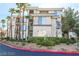 Exterior view of a modern condo building with palm trees and landscaping at 7167 S Durango Dr # 203, Las Vegas, NV 89113