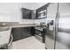 Modern kitchen with stainless steel appliances and granite countertops at 7167 S Durango Dr # 203, Las Vegas, NV 89113