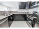 Modern kitchen with stainless steel appliances and dark cabinetry at 7167 S Durango Dr # 203, Las Vegas, NV 89113