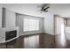 Living room with hardwood floors, fireplace, and ceiling fan at 7167 S Durango Dr # 203, Las Vegas, NV 89113