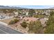 Expansive aerial view of a residential area showcasing a single-story house with a terra cotta-tiled roof at 7450 Via Olivero Ave, Las Vegas, NV 89117