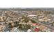 Wide aerial shot of a residential community showcasing diverse homes, landscaping, and nearby commercial areas at 7450 Via Olivero Ave, Las Vegas, NV 89117