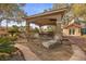 Secluded backyard features a lounge chair and access to a covered patio at 7450 Via Olivero Ave, Las Vegas, NV 89117